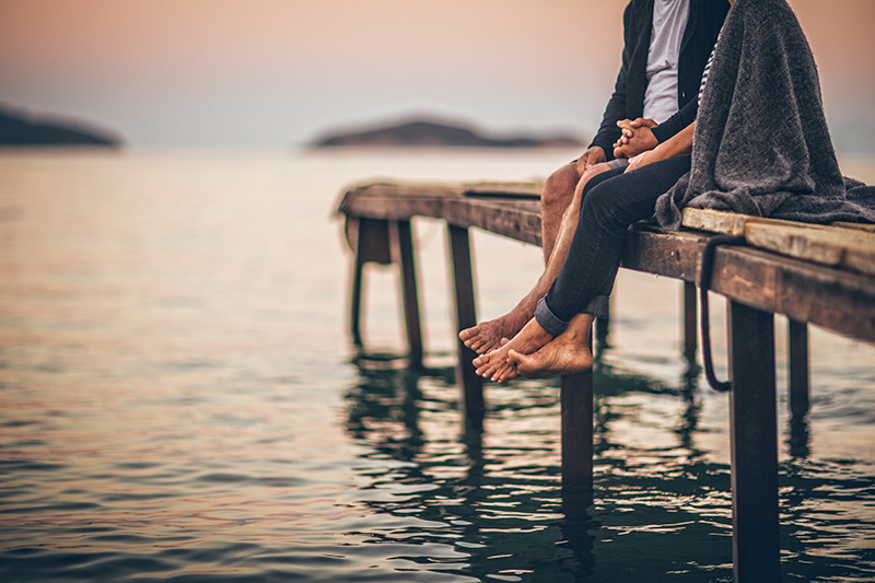 Couple sitting on a jetty